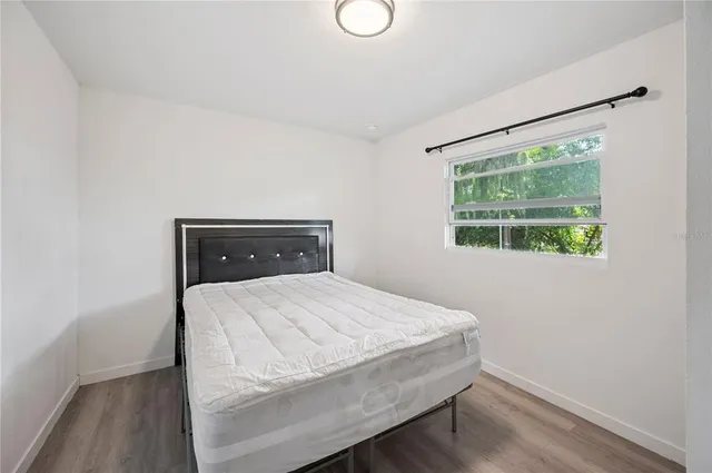 a bedroom with a bed and window