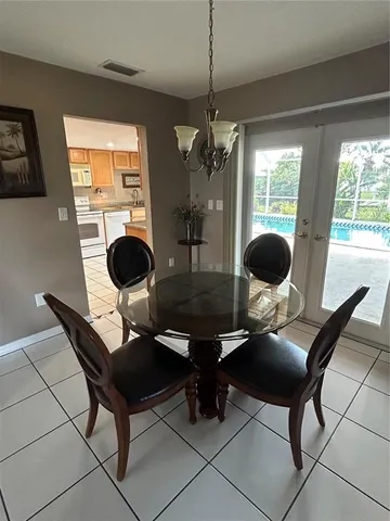 a view of a dining room with furniture wooden floor and chandelier