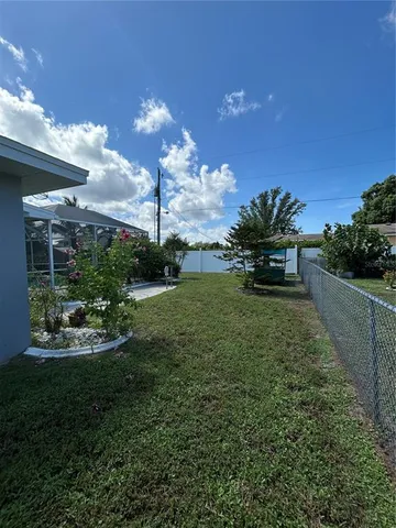 a view of an house with backyard space and garden