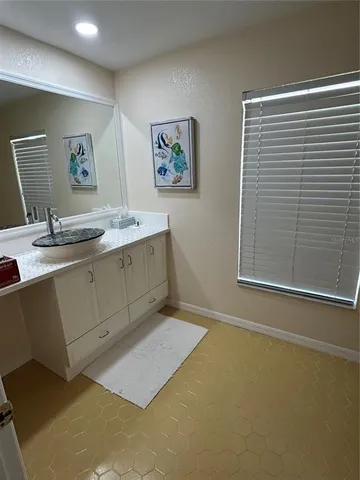 a bathroom with a sink a mirror and a window