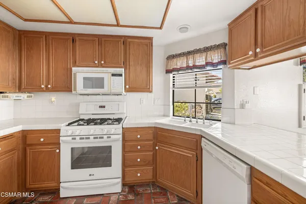 a kitchen with stainless steel appliances granite countertop a sink stove and microwave