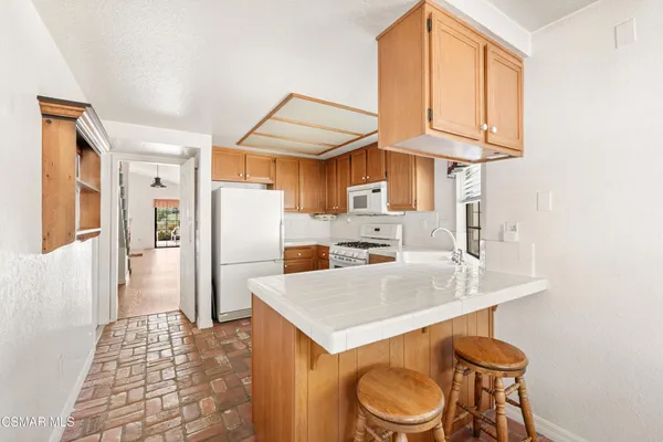 a kitchen with stainless steel appliances a refrigerator and a stove