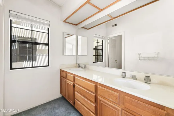 a bathroom with a granite countertop sink mirror and double
