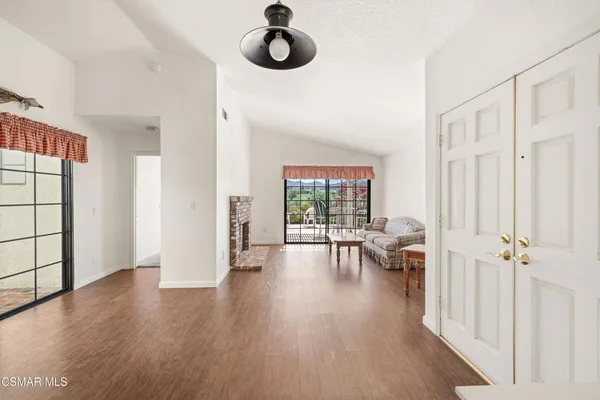 a view of a livingroom with furniture and hardwood floor