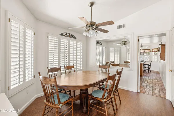 a view of a dining room with furniture window and wooden floor