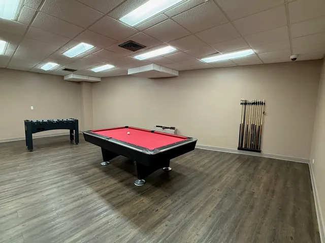 a room with pool table and windows