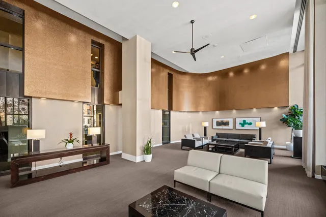a living room with furniture a large window and a flat screen tv