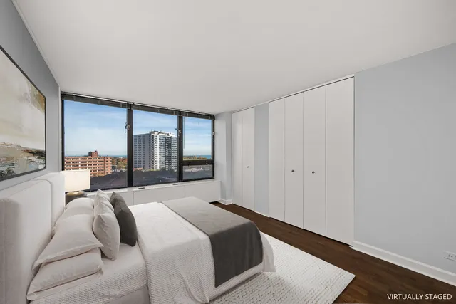 a bedroom with a bed and large window