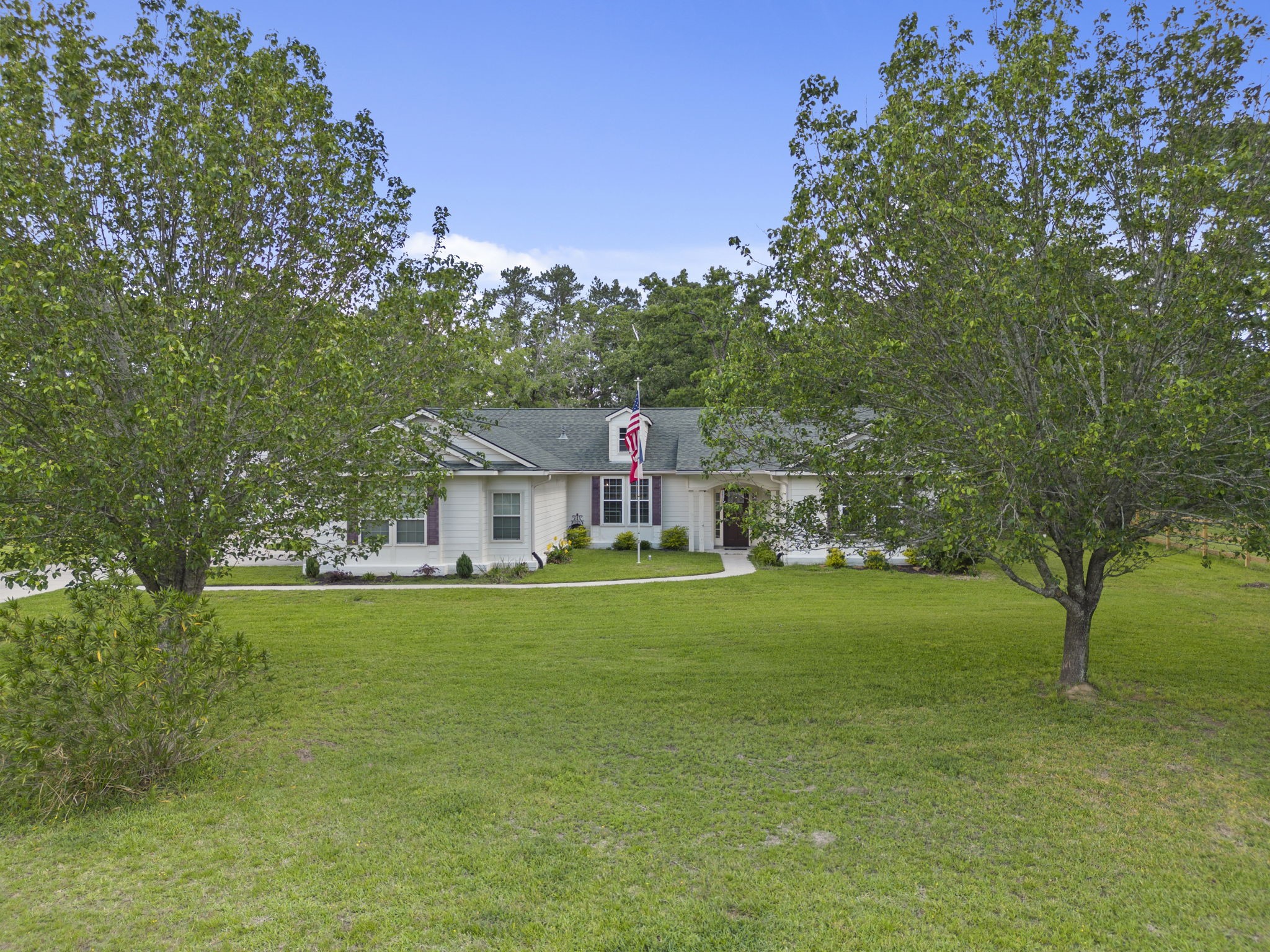 23200 Baneberry Road Magnolia, TX 77355 - Photo 1 of 39 a view of a house with a big yard potted plants and large trees