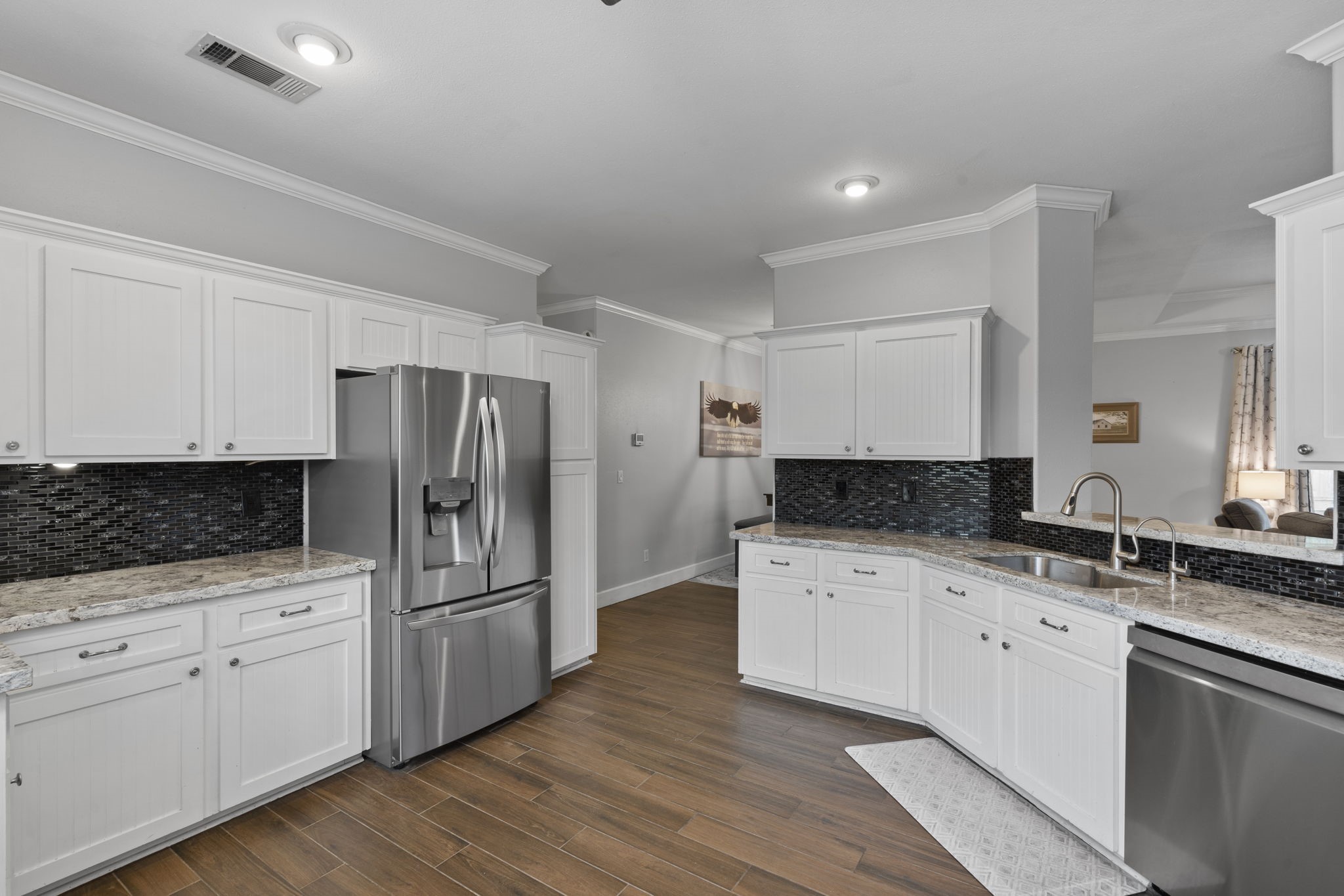 23200 Baneberry Road Magnolia, TX 77355 - Photo 15 of 39 a kitchen with granite countertop a sink stove and refrigerator