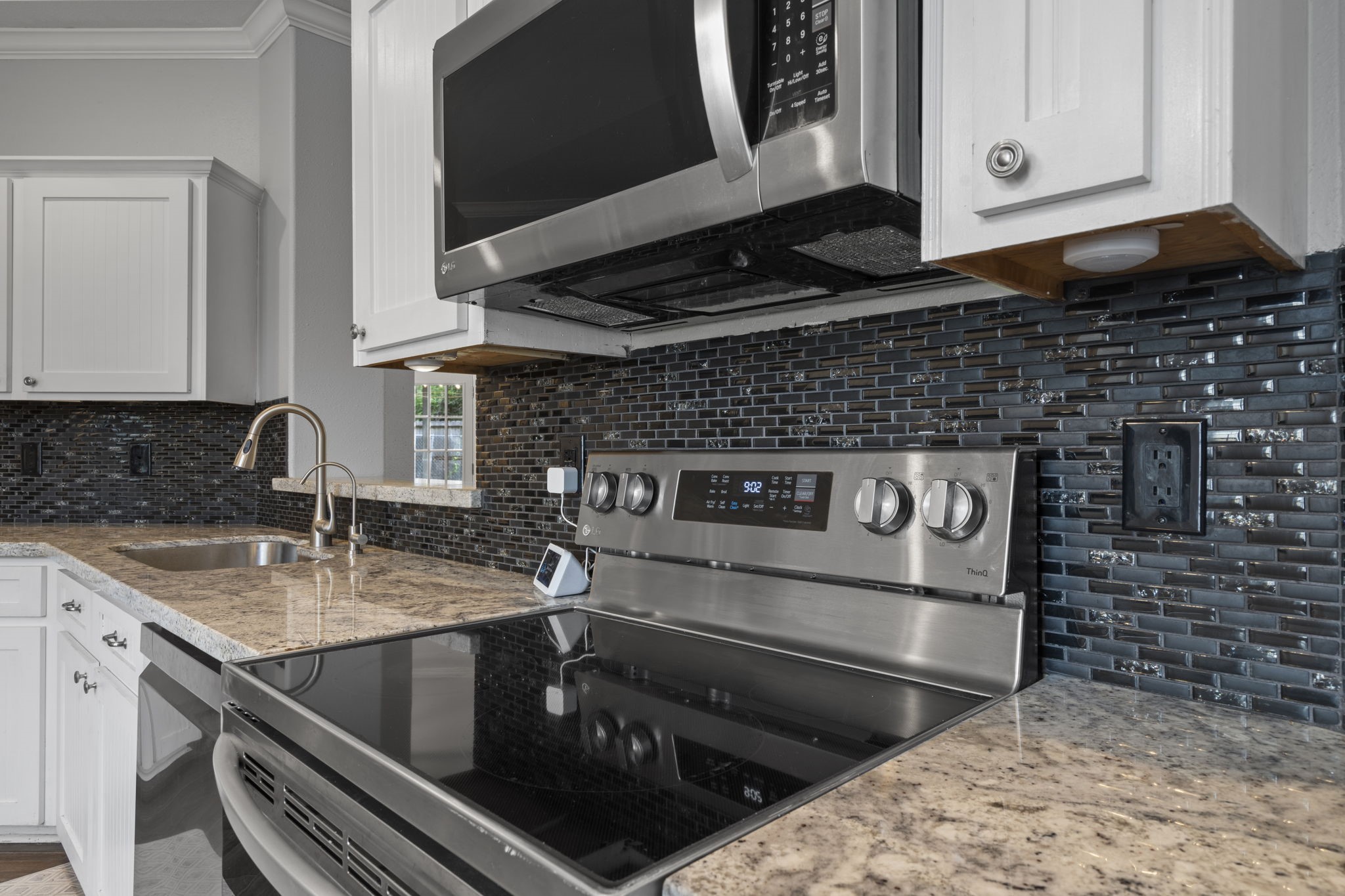 23200 Baneberry Road Magnolia, TX 77355 - Photo 17 of 39 a kitchen with a stove and a microwave