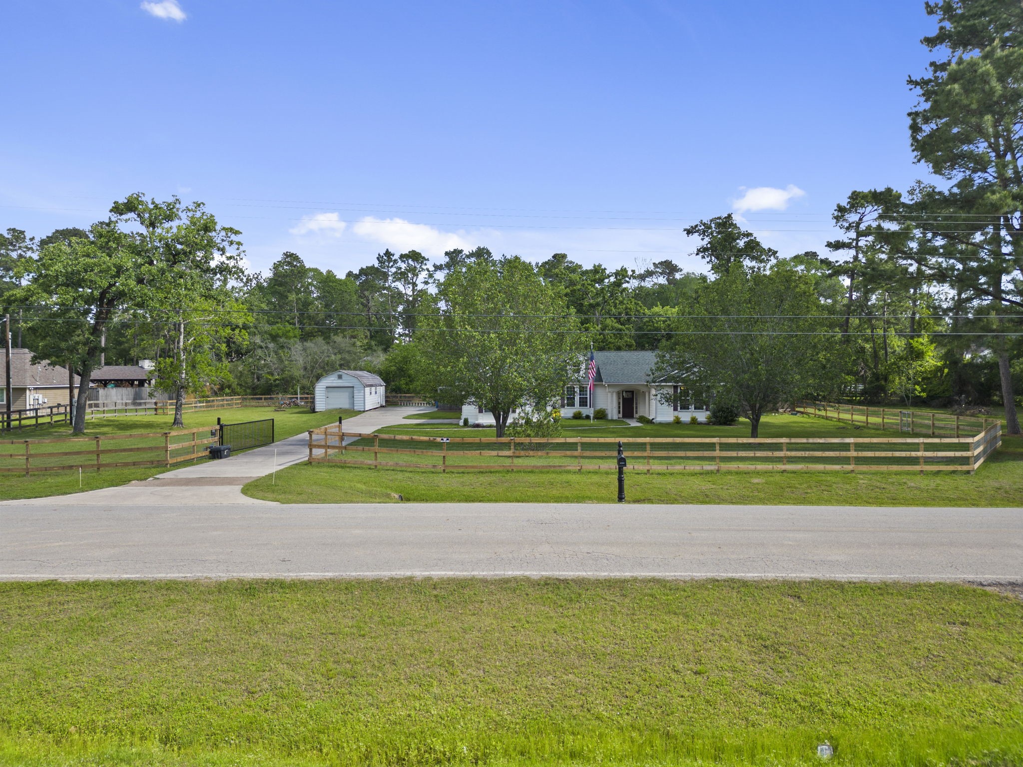 23200 Baneberry Road Magnolia, TX 77355 - Photo 3 of 39 a green field with lots of trees in the background