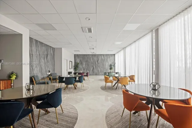 a living room with furniture and floor to ceiling window