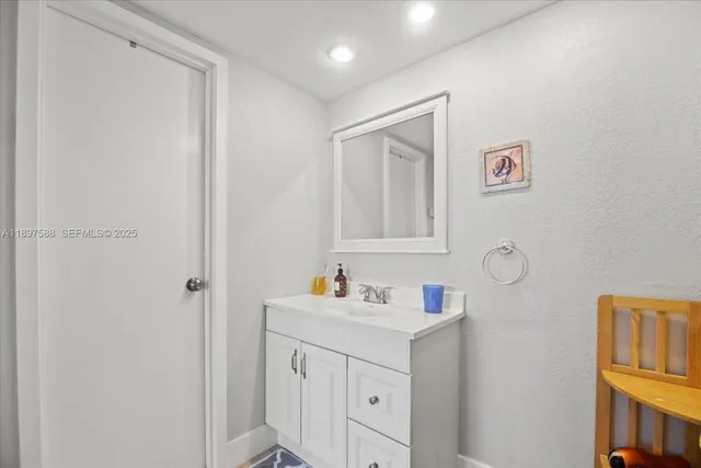 a bathroom with a sink vanity and a mirror
