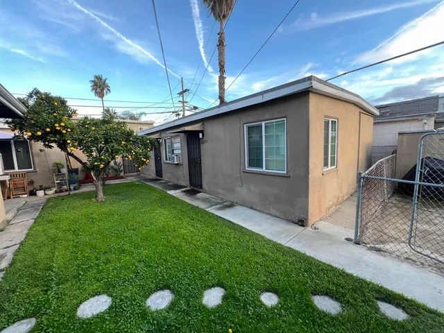 a yellow house with garden in front of it