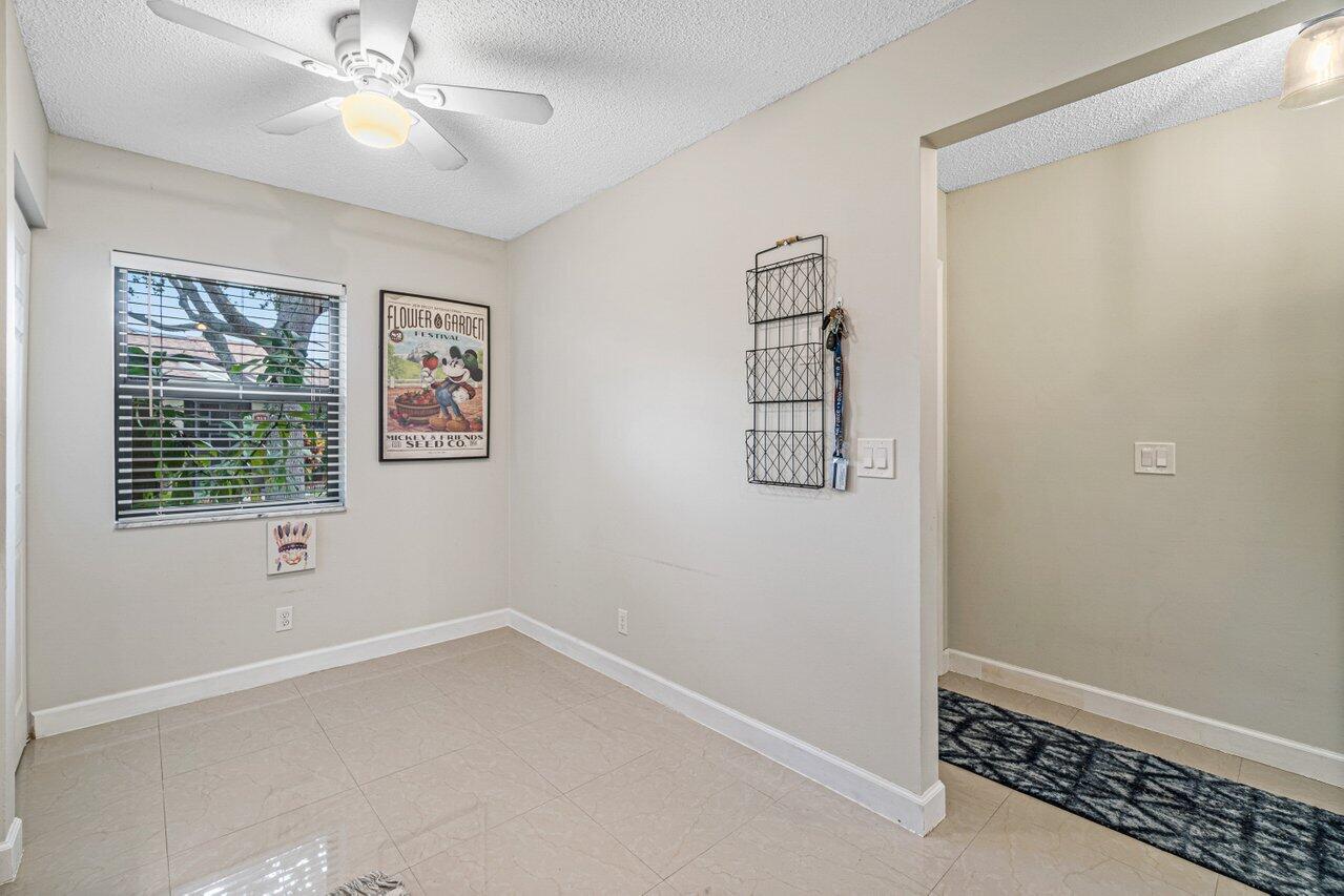241 Meadows Drive Boynton Beach, FL 33436 - Photo 12 of 24 an empty room with windows and fan