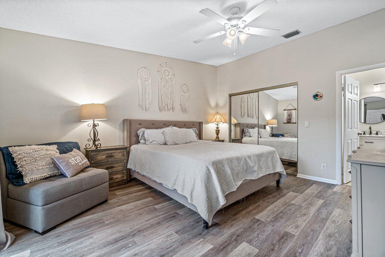 241 Meadows Drive Boynton Beach, FL 33436 - Photo 13 of 24 a spacious bedroom with a bed and a couch