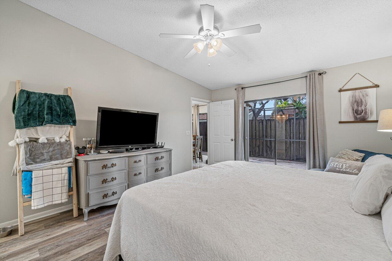 241 Meadows Drive Boynton Beach, FL 33436 - Photo 14 of 24 a bedroom with a bed and a flat screen tv