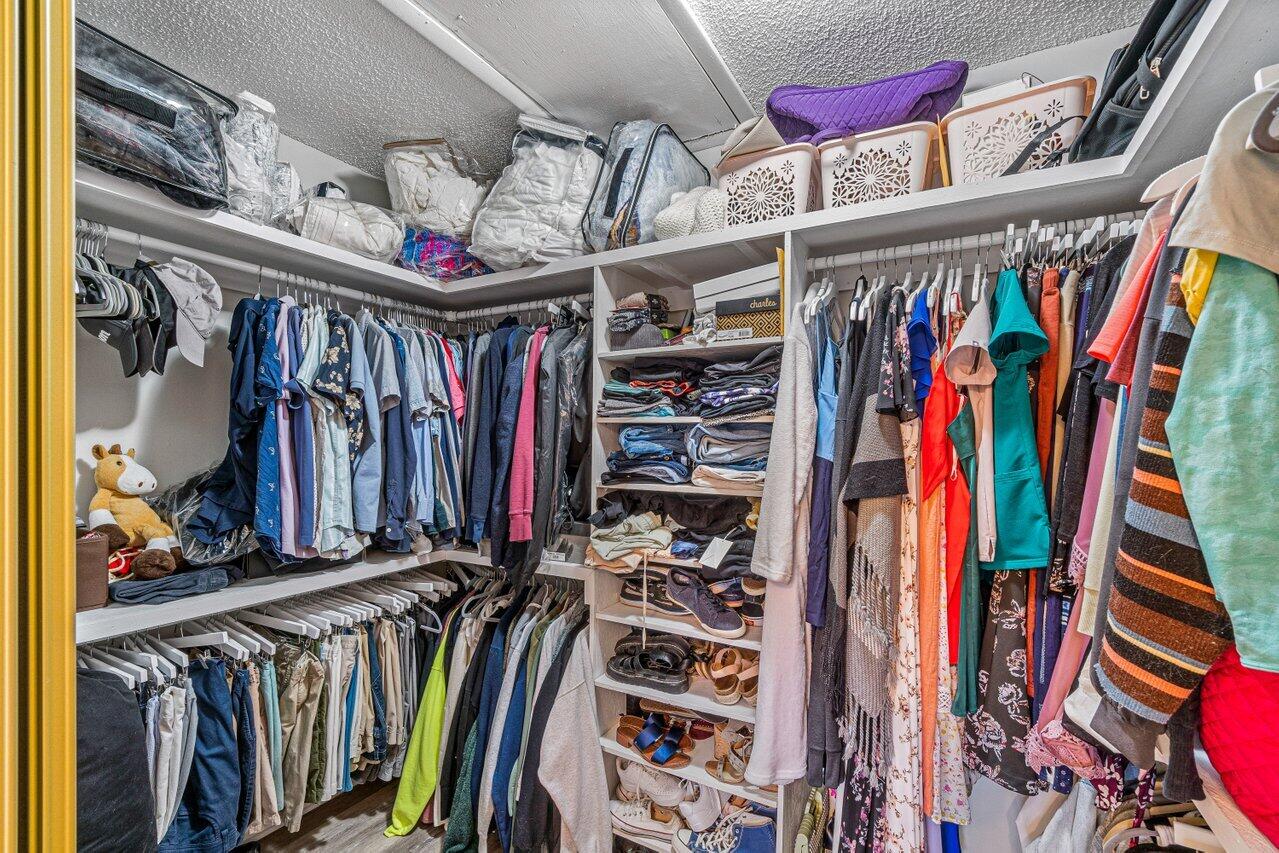 241 Meadows Drive Boynton Beach, FL 33436 - Photo 17 of 24 a view of walk in closet with clothes and shoes