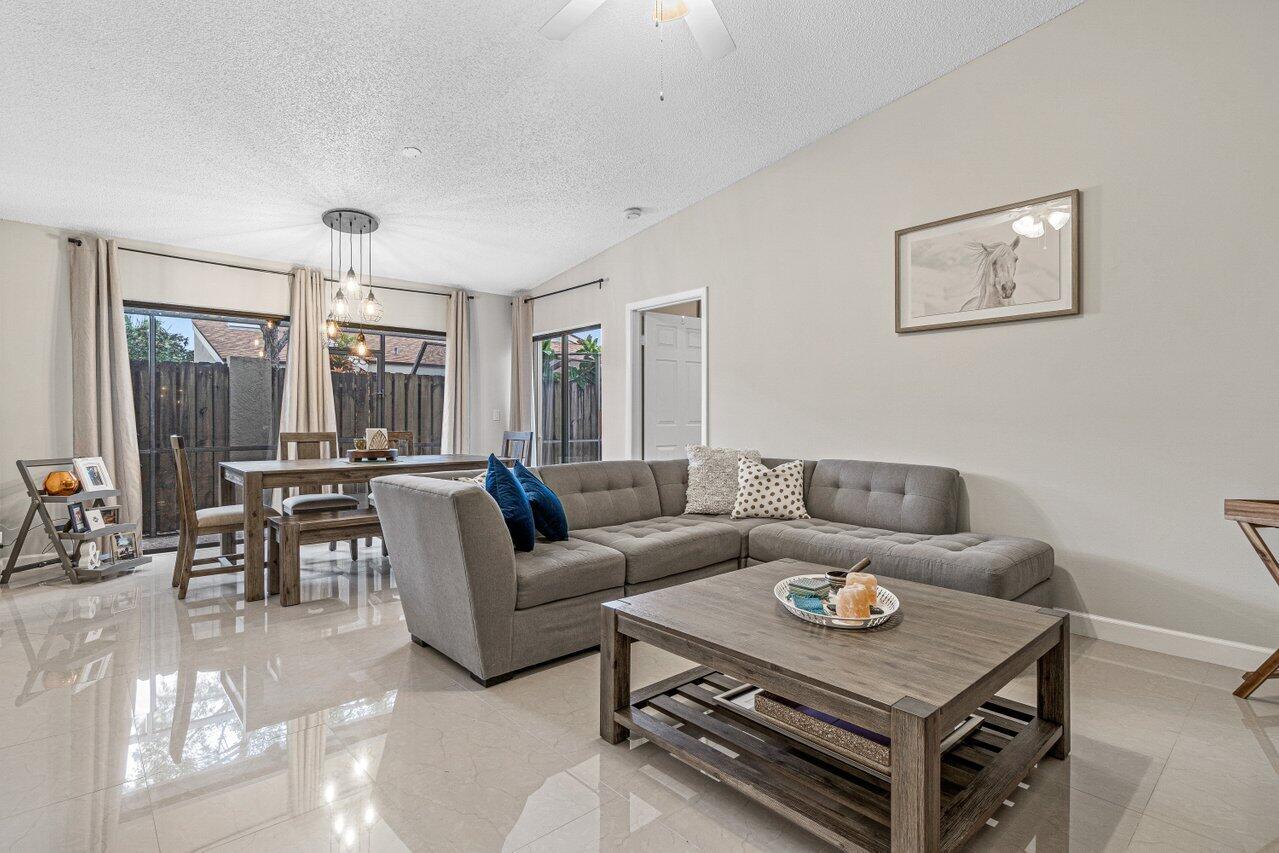 241 Meadows Drive Boynton Beach, FL 33436 - Photo 5 of 24 a living room with furniture and a large window