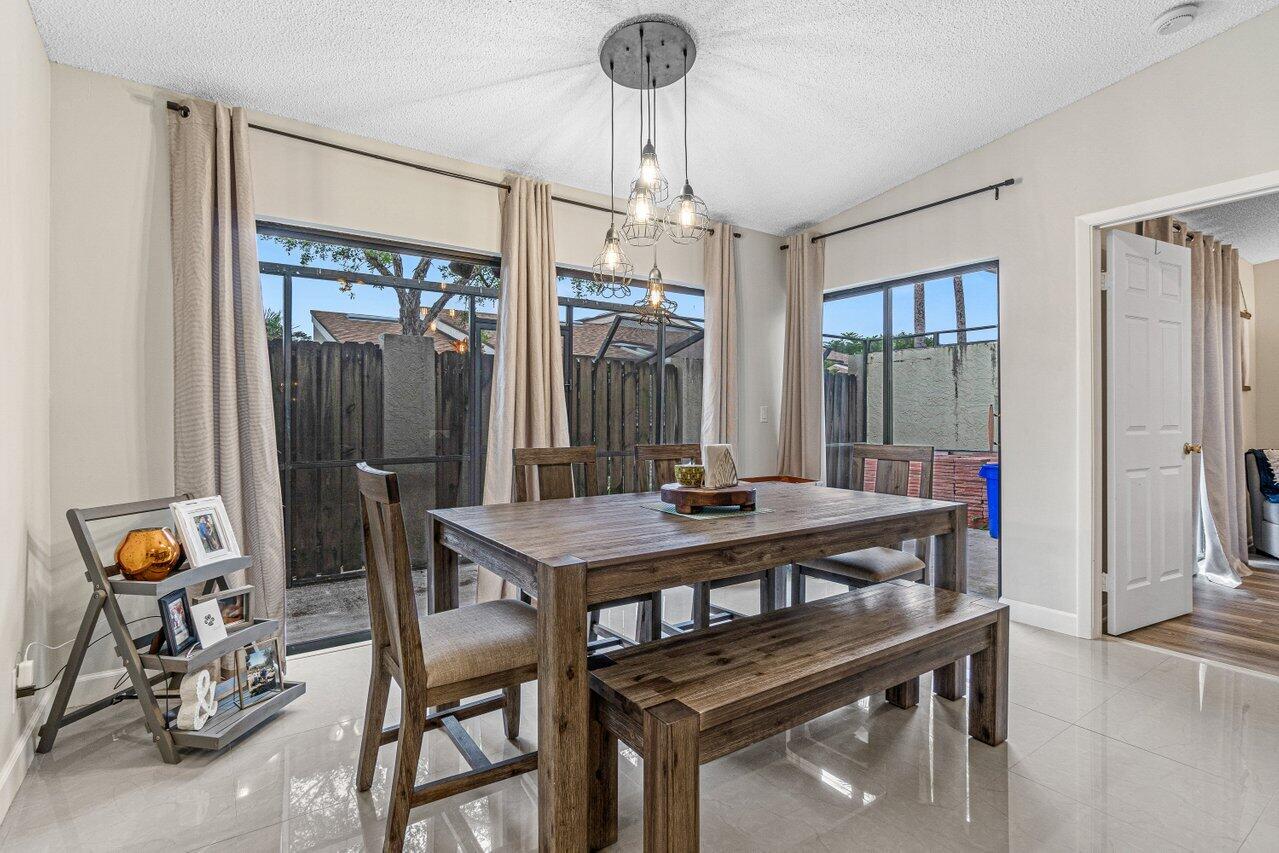 241 Meadows Drive Boynton Beach, FL 33436 - Photo 7 of 24 a view of a dining room with furniture window and outside view