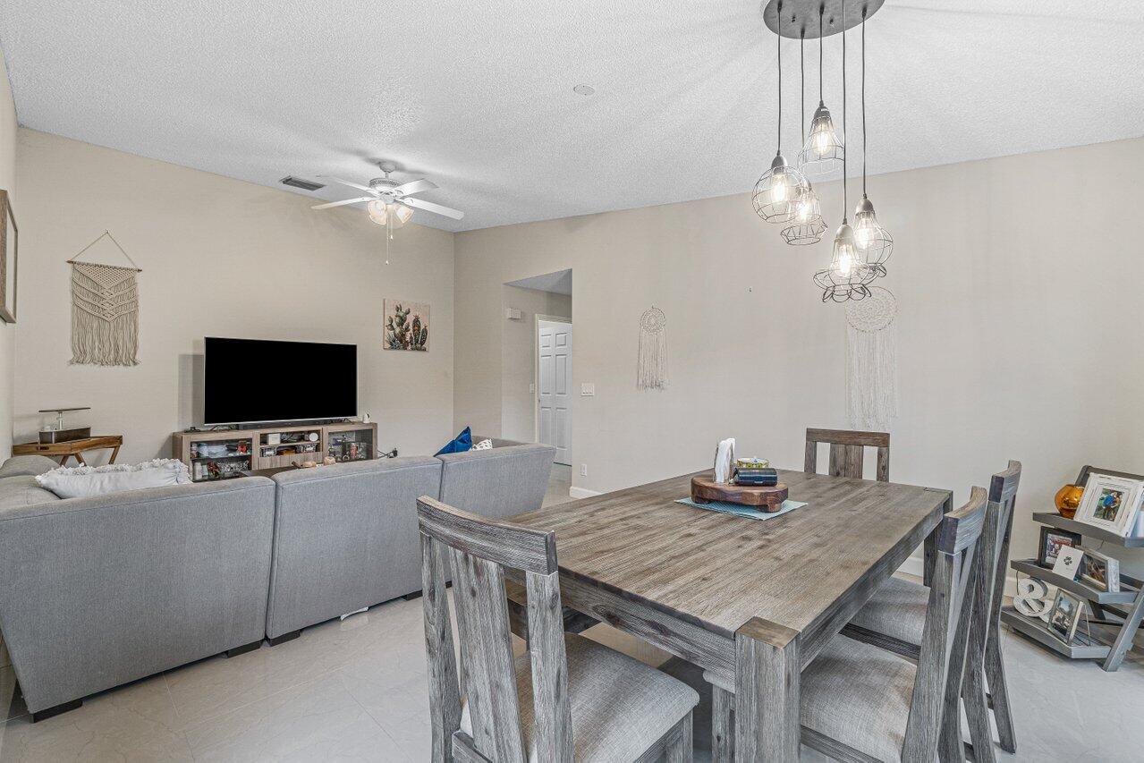 241 Meadows Drive Boynton Beach, FL 33436 - Photo 8 of 24 a living room with furniture and a flat screen tv
