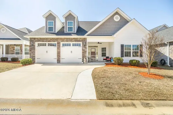 a view of a white building with large windows