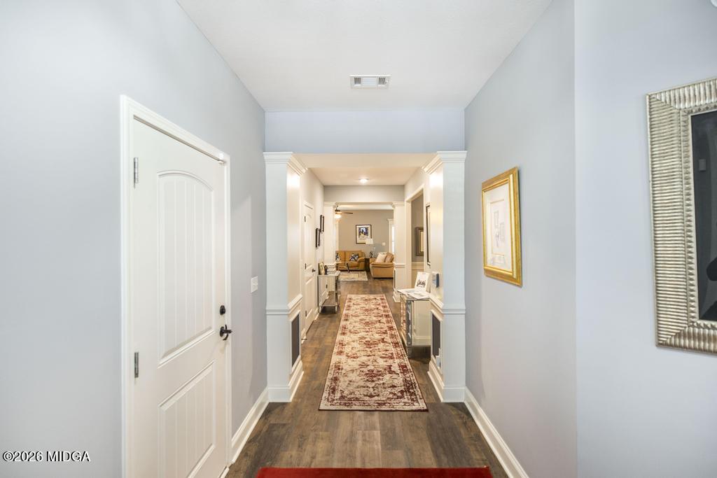 137 Shady Oak Drive Perry, GA 31069 - Photo 11 of 37 a view of a hallway with wooden floor and a living room