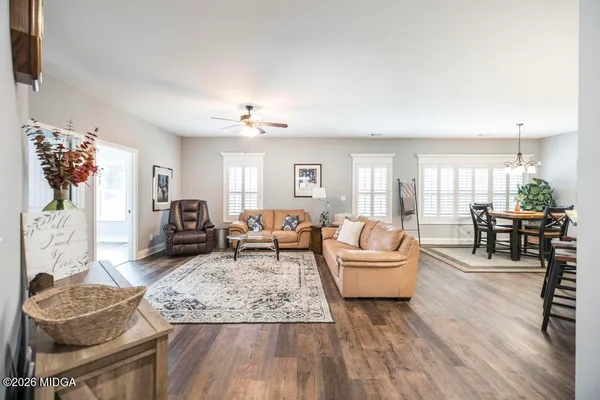 a living room with furniture and wooden floor