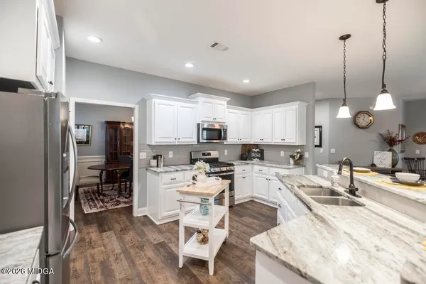 a large kitchen with a table and chairs