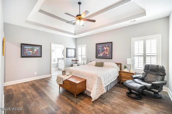 a spacious bedroom with a bed couch and a large window