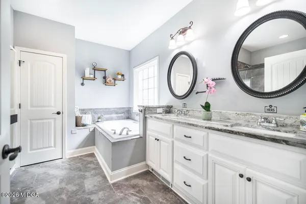 a bathroom with a double vanity sink and a mirror