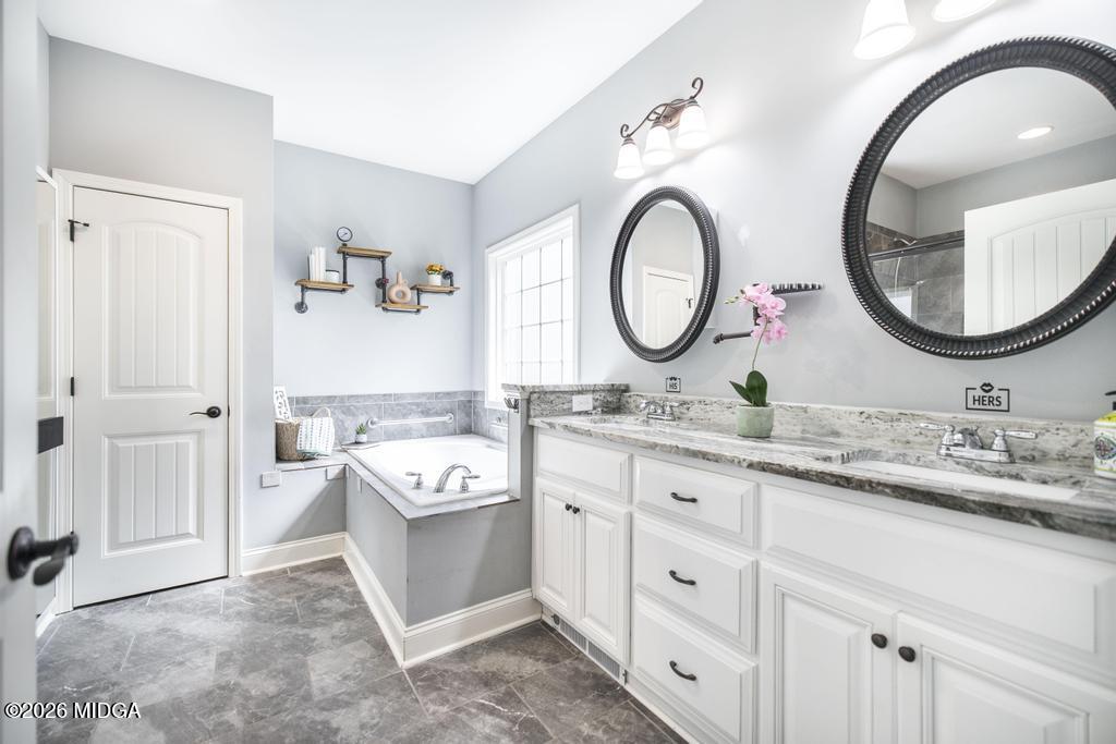 137 Shady Oak Drive Perry, GA 31069 - Photo 25 of 37 a bathroom with a double vanity sink and a mirror