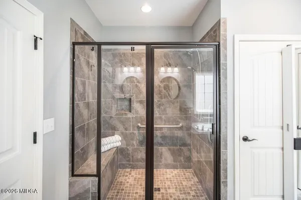 a bathroom with a glass shower door