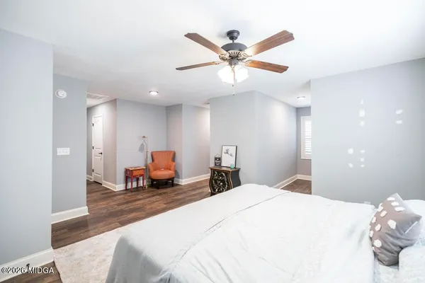 a bedroom with a large bed and a chandelier