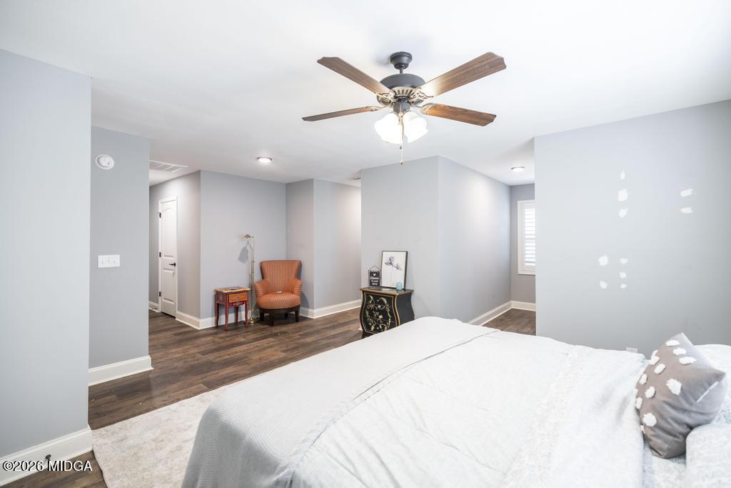137 Shady Oak Drive Perry, GA 31069 - Photo 30 of 37 a bedroom with a large bed and a chandelier