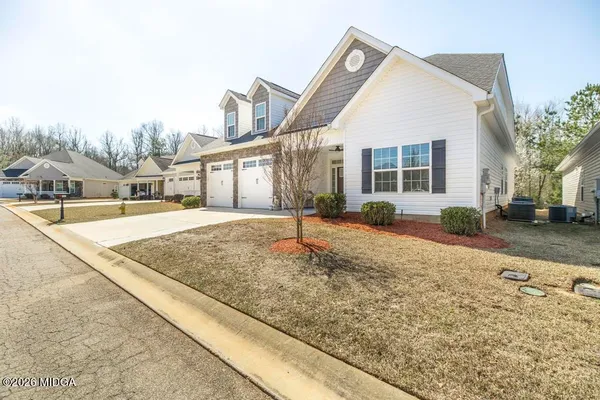 a view of a white house with a yard