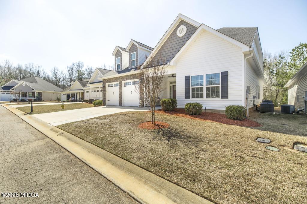 137 Shady Oak Drive Perry, GA 31069 - Photo 3 of 37 a view of a white house with a yard