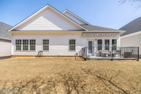 a view of a house with a yard covered in snow