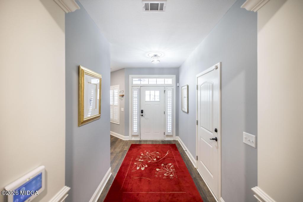 137 Shady Oak Drive Perry, GA 31069 - Photo 5 of 37 a view of a hallway view with wooden floor and a bathroom