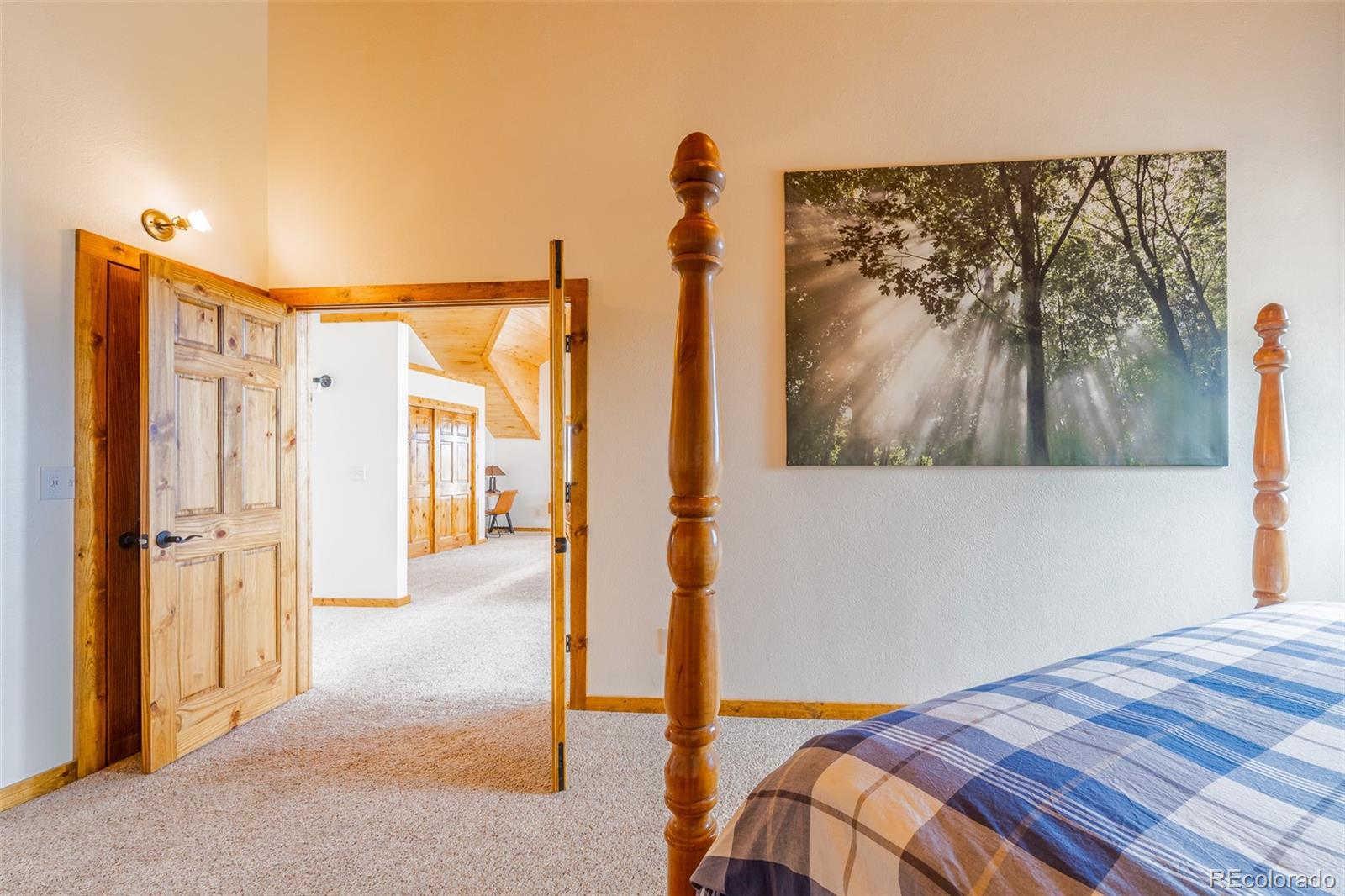 8221 Remington Road Como, CO 80432 - Photo 30 of 49 a bedroom with a bed and a painting on the wall