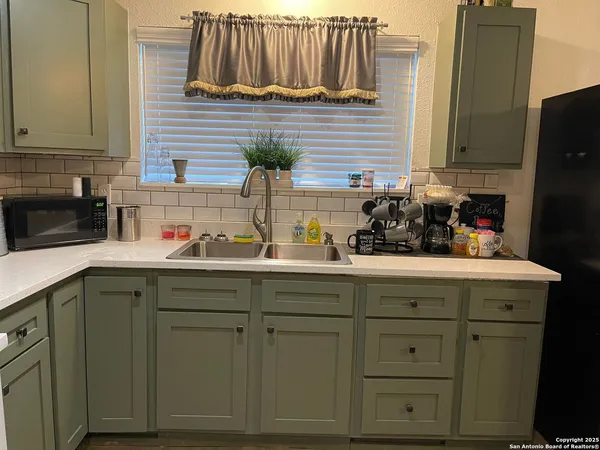 a kitchen with cabinets and white appliances
