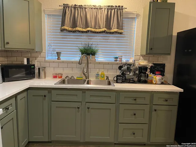 a kitchen with cabinets and white appliances