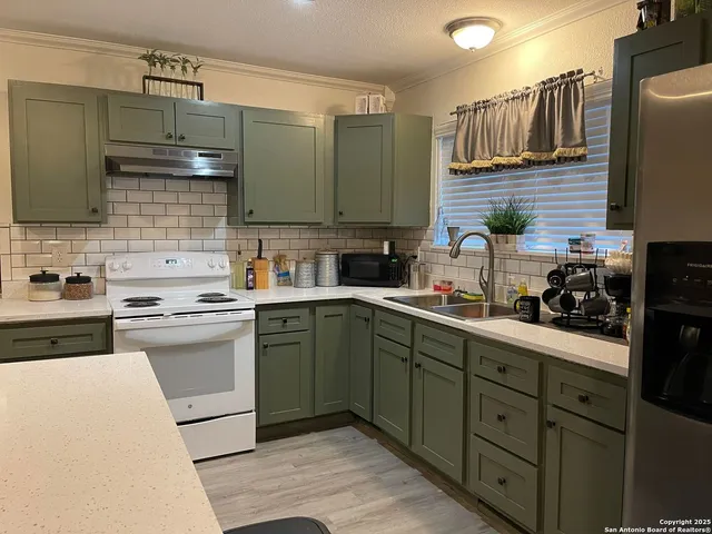 a kitchen with a sink cabinets and stainless steel appliances