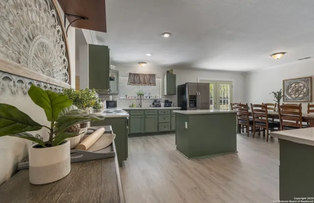 a living room with furniture windows and a kitchen