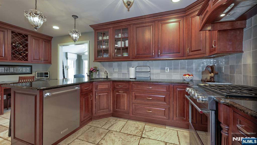 23 Erli Street Wayne, NJ 07470 - Photo 13 of 49 a kitchen with stainless steel appliances granite countertop a stove cabinets and refrigerator