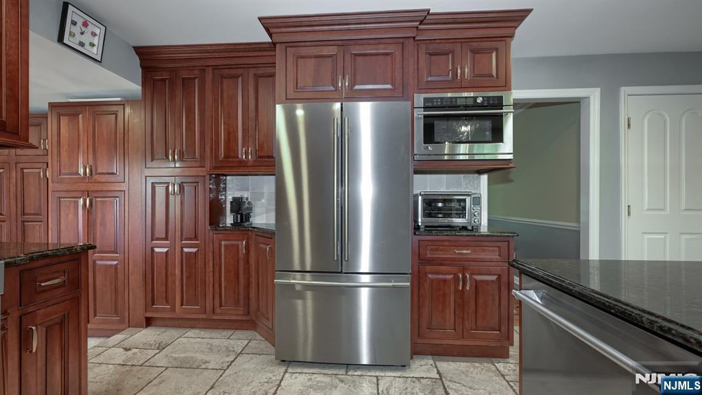 23 Erli Street Wayne, NJ 07470 - Photo 15 of 49 a kitchen with stainless steel appliances granite countertop a refrigerator and a stove top oven