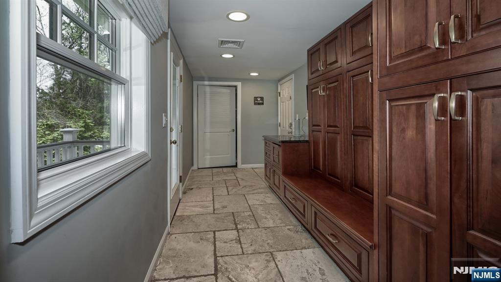 23 Erli Street Wayne, NJ 07470 - Photo 18 of 49 a view of a hallway with wooden floor and staircase
