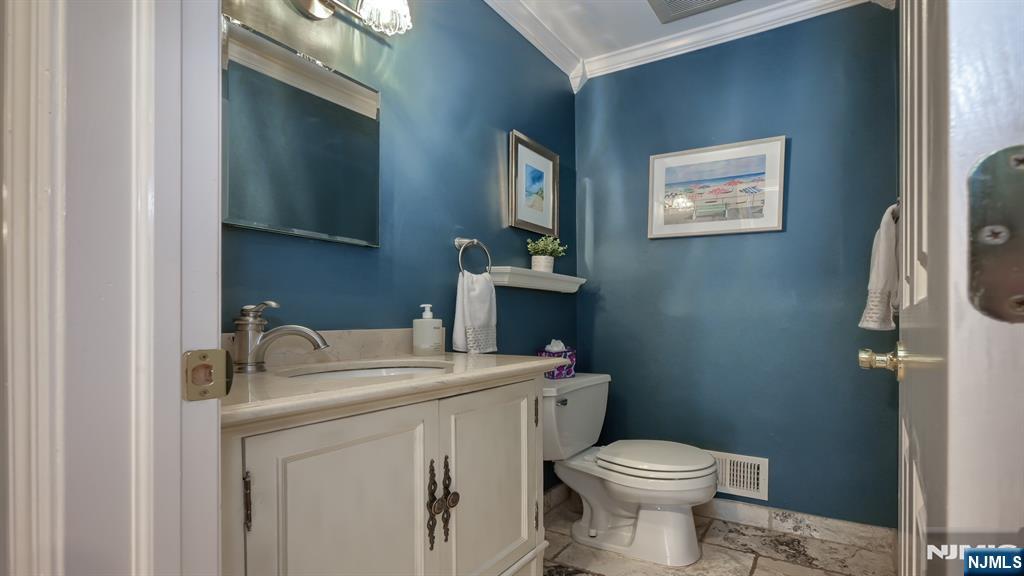 23 Erli Street Wayne, NJ 07470 - Photo 24 of 49 a bathroom with a sink toilet and vanity
