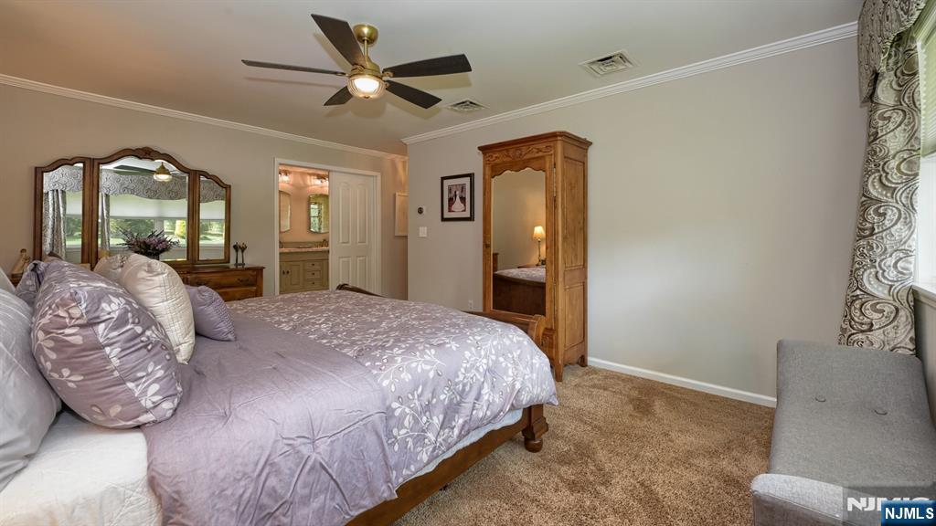 23 Erli Street Wayne, NJ 07470 - Photo 27 of 49 a bedroom with a bed and a dresser with the shoe rack